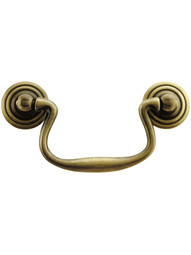 Swan-Neck Brass Bail Pull with Ringed Round Rosettes ‚Äì 3‚Äù Center-to-Center in Antique Brass Finish.